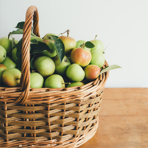 Basket filled with green apples